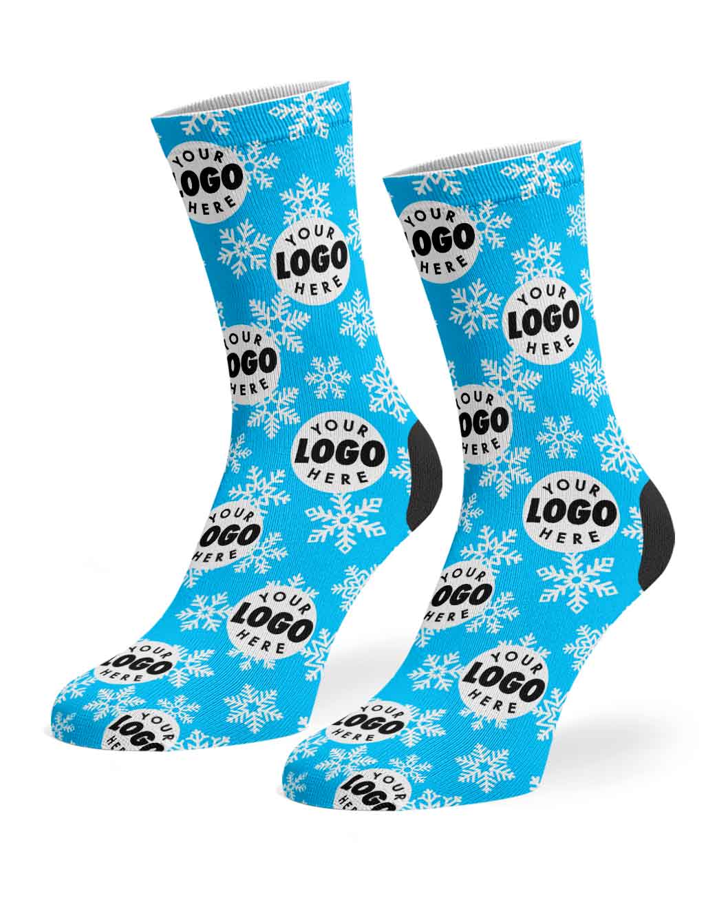 A pair of blue crew socks with a white snowflake pattern and a repeating circular placeholder logo design that reads 'YOUR LOGO HERE', shown on a plain white background.