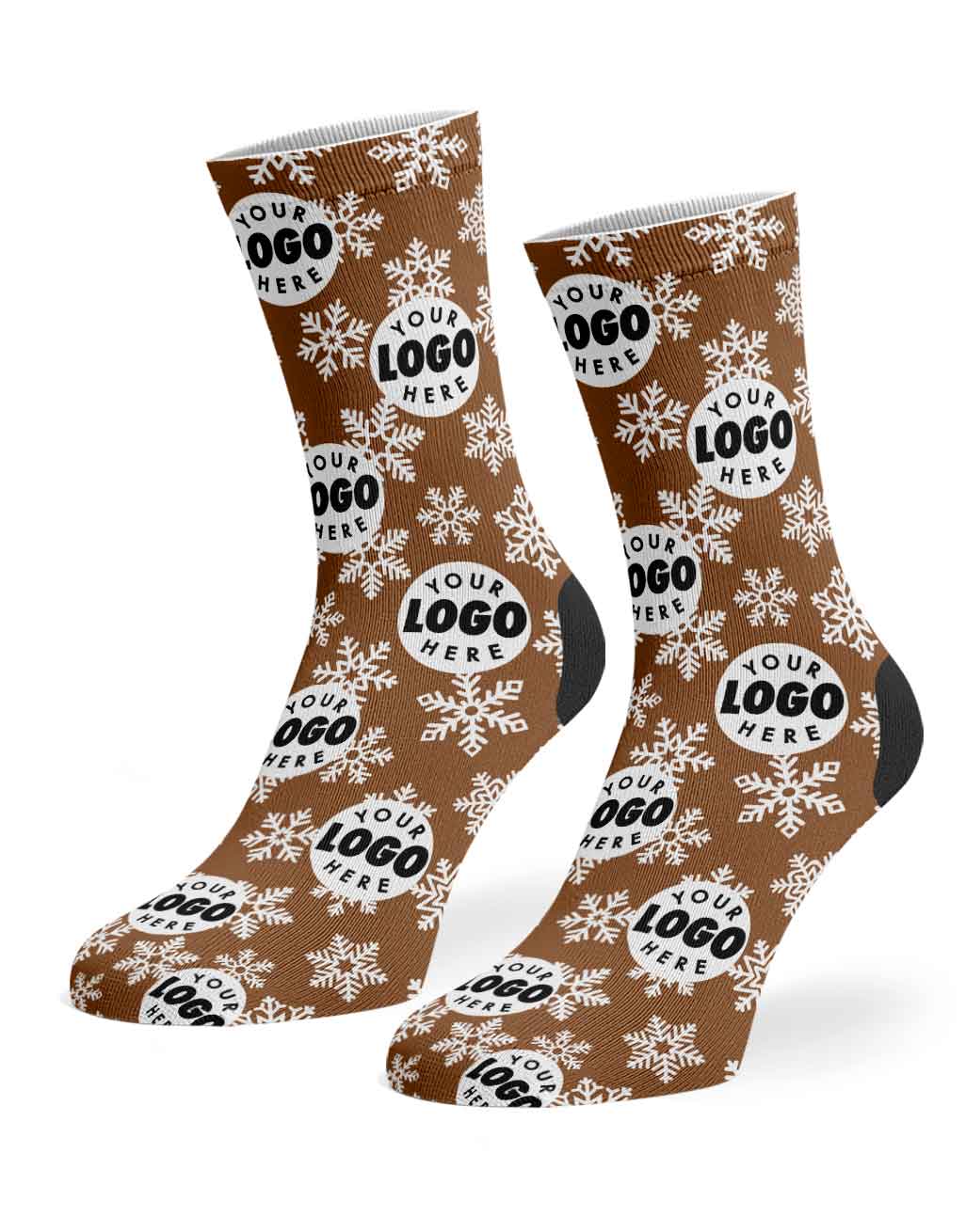 A pair of brown crew socks with a white snowflake pattern and circular placeholder logos reading 'YOUR LOGO HERE', shown on a plain white background.